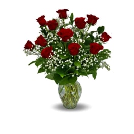 Red roses arranged in a clear glass vase with baby's breath