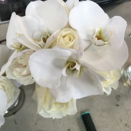White orchids and cream roses in a bouquet