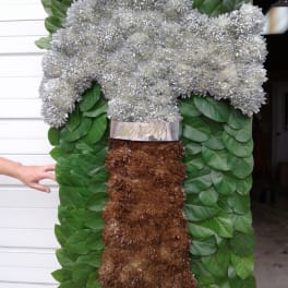 Large floral standing spray with silver blooms and green foliage