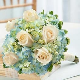 Bouquet of cream roses and blue hydrangeas