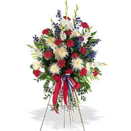 Standing floral spray with red, white, and blue flowers on an easel
