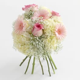 Bouquet of pink and cream flowers with a central rose