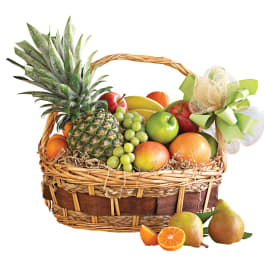 Fruit basket with pineapple, grapes, apples, oranges, mangoes, and pears