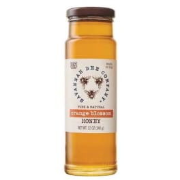 Bottle of orange blossom honey with a labeled cap
