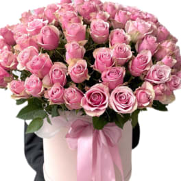 Arrangement of light pink roses in a hat box