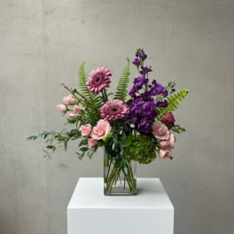 Pink and purple mixed bouquet in a clear glass vase