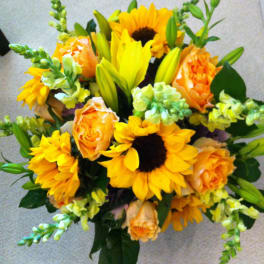 Bouquet of yellow sunflowers, orange roses, and lilies