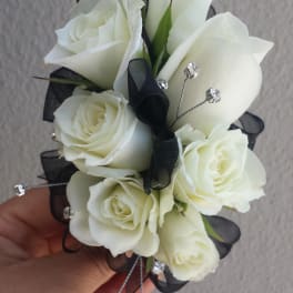 White rose corsage with black ribbon and silver accents