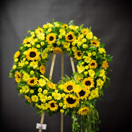 Large yellow floral wreath on a wooden easel