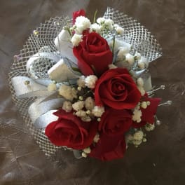 Red rose bouquet with white filler flowers and silver ribbon