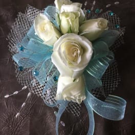 White rose bouquet with blue ribbon and silver mesh wrap