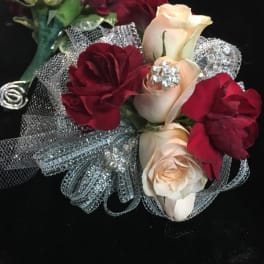 Small bouquet of cream and burgundy roses with silver mesh wrap