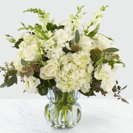 White floral bouquet in a clear glass vase
