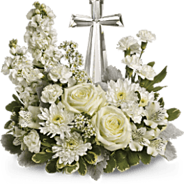 White floral arrangement with a silver cross centerpiece