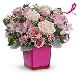 Pink and white rose bouquet in a bright pink vase with a ribbon accent