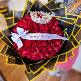 Bouquet of red roses with a silver crown and white ribbon