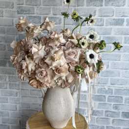 Blush roses in a white vase with white anemones and ribbon accents