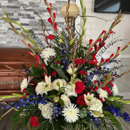 Large red, white, and blue floral arrangement in a room