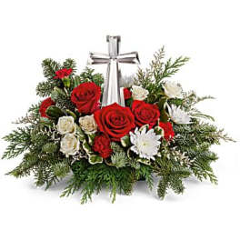 Red and white rose arrangement with a silver cross centerpiece