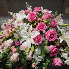Large bouquet of pink roses and white lilies with mixed filler flowers