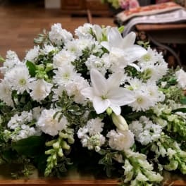 White floral arrangement with lilies and small white blooms