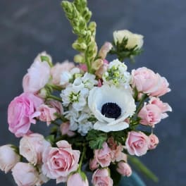 Bouquet of pink roses and white anemones with a tall green spike