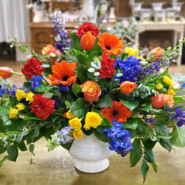 Colorful mixed flower arrangement in a white vase