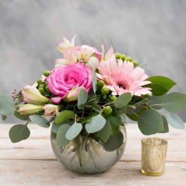 Pink rose and gerbera bouquet in a glass vase with eucalyptus