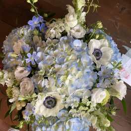 Blue and white bouquet with hydrangeas, anemones, and snapdragons