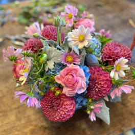 Mixed bouquet of pink, blue, and white flowers