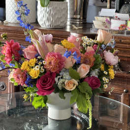 Colorful mixed flower arrangement in a white vase