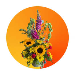 Tall bouquet of sunflowers, yellow daisies, and purple blooms in a vase