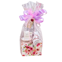 Gift basket wrapped in clear plastic with a lavender bow and floral box