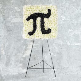 Square floral easel display with a black symbol on white flowers