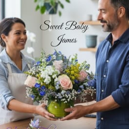 Mixed bouquet in a green vase with pink and blue flowers