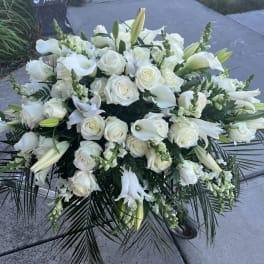 Large white floral spray with roses, lilies, and calla lilies
