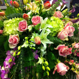 Mixed bouquet of pink roses, lilies, and purple calla lilies