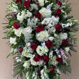 Standing spray of red and white roses with mixed white blooms