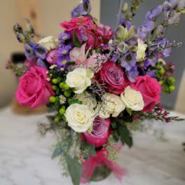Bouquet of pink, white, and purple flowers in a glass vase
