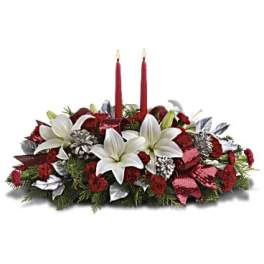 Red and white floral centerpiece with two red candles