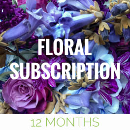 Purple and blue floral arrangement with large text overlay
