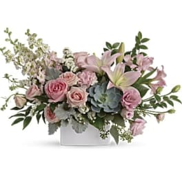 Pink roses and lilies in a white rectangular vase