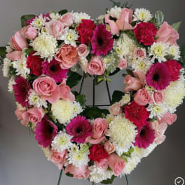 Heart-shaped floral wreath with pink roses, white mums, and magenta gerberas