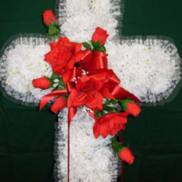 White floral cross with red roses and ribbon