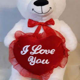 White teddy bear holding a red heart with "I Love You" text