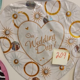 Heart-shaped wedding day balloon with gold circle and starburst pattern