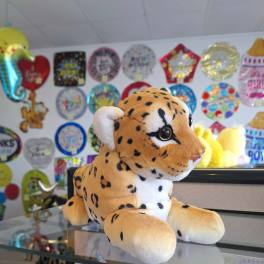 Plush spotted big cat toy on a counter