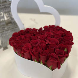 Heart-shaped box filled with red roses