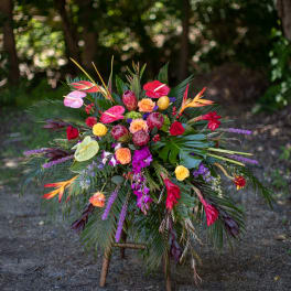 Tropical floral arrangement with red, pink, orange, and purple blooms