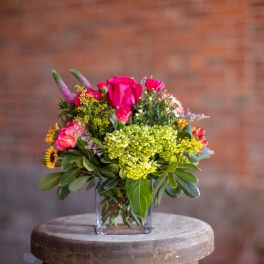 Pink and yellow mixed bouquet in a clear glass vase